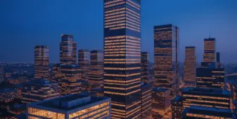 Modern corporate office towers at dusk representing strategic business transformation and financial restructuring