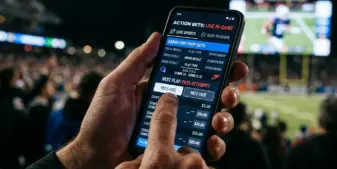 Smartphone displaying sports betting app with live in-game wagering options
