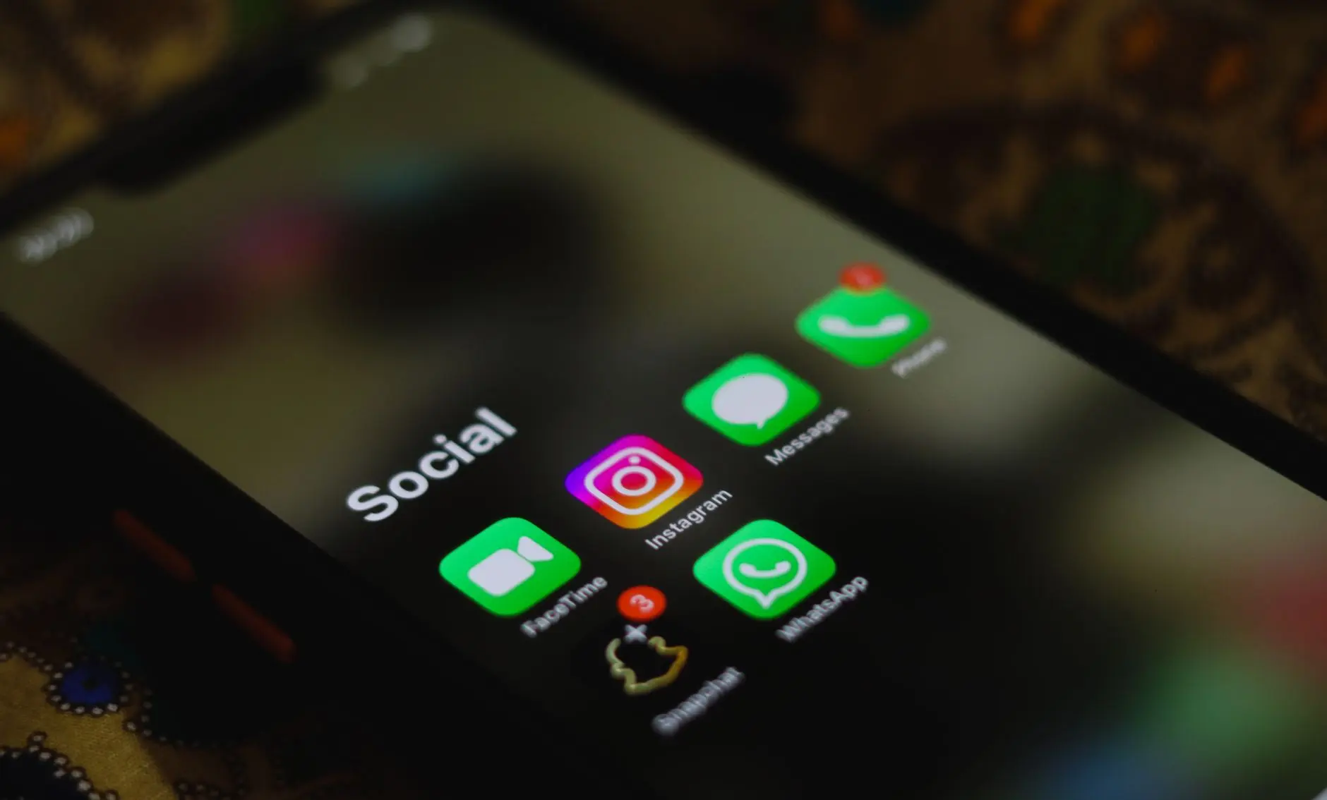 A close-up of a phone screen displaying social media app icons.