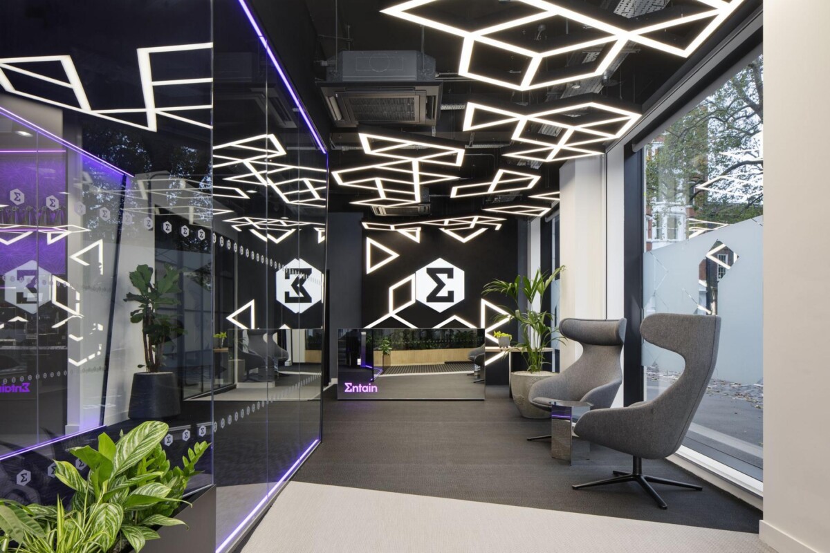 Modern office interior of Entain Group with stylish lighting and furniture.