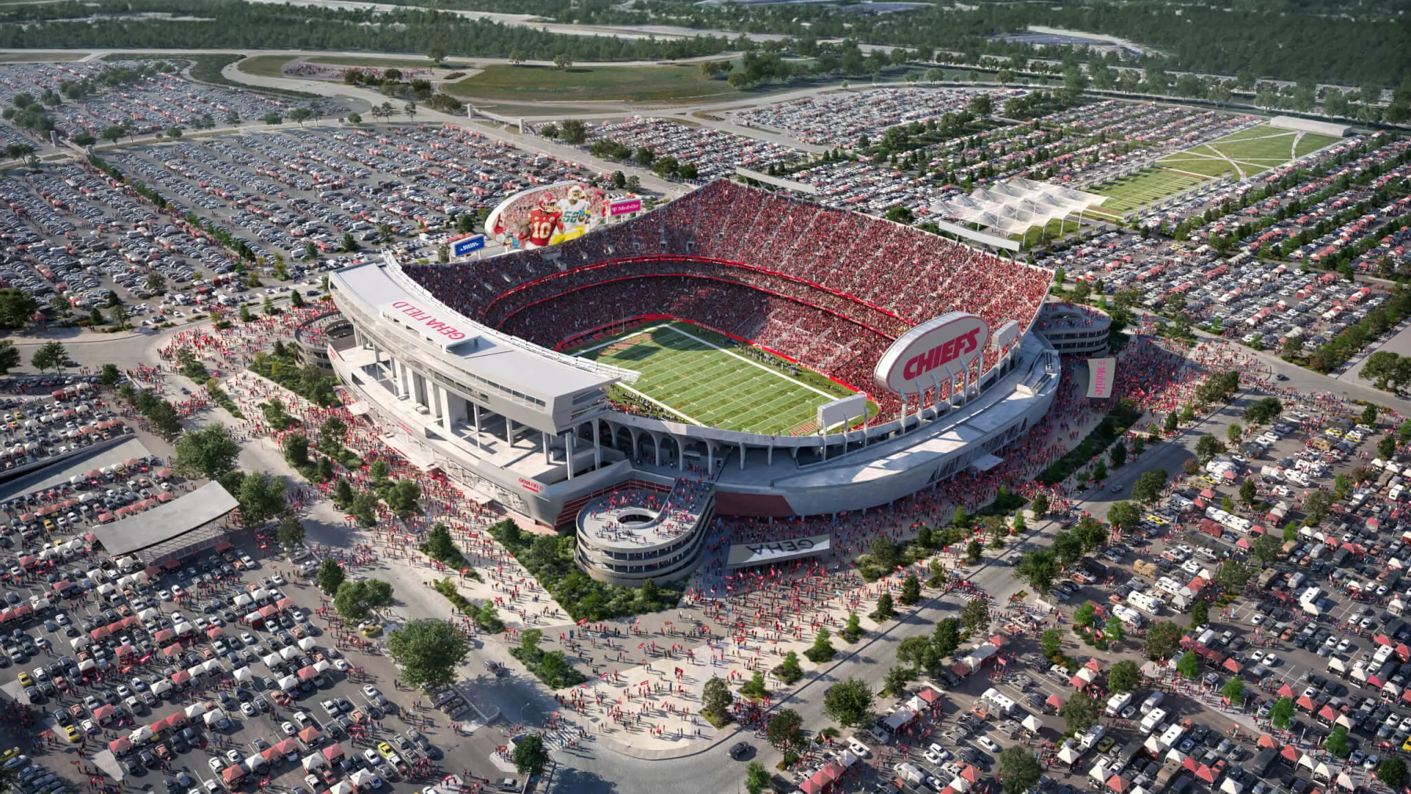 Aerial view of Arrowhead Stadium filled with fans in red, surrounded by expansive parking lots.