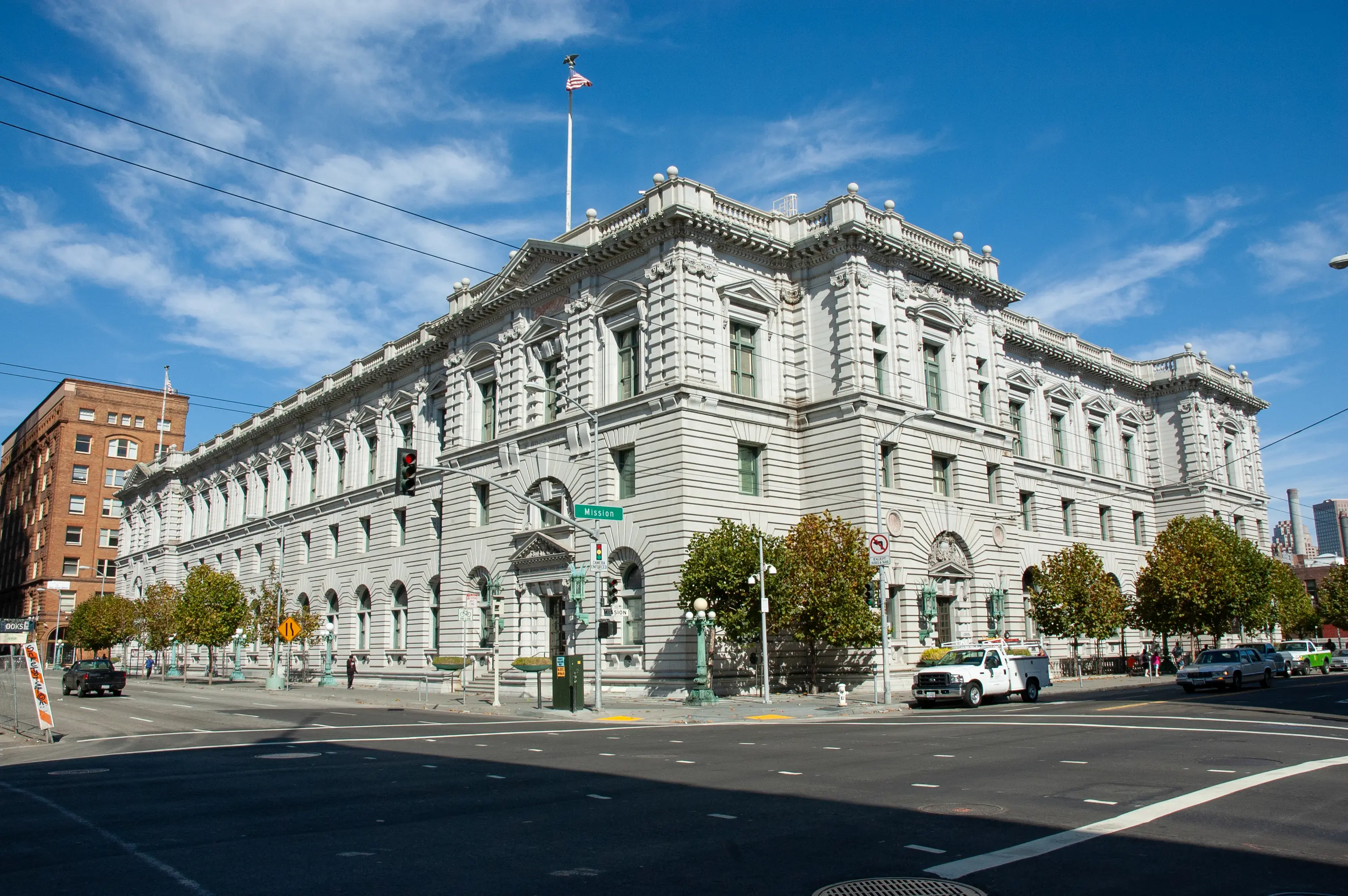 Ninth Circuit Court of Appeals building in San Francisco with traffic and trees in view.