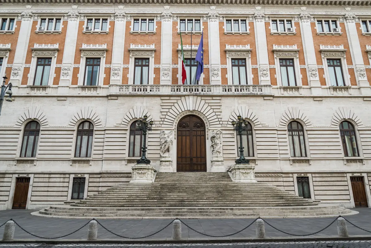Exterior view of the Palazzo Madama facade with the Italian and European Union flags flying above the main entrance