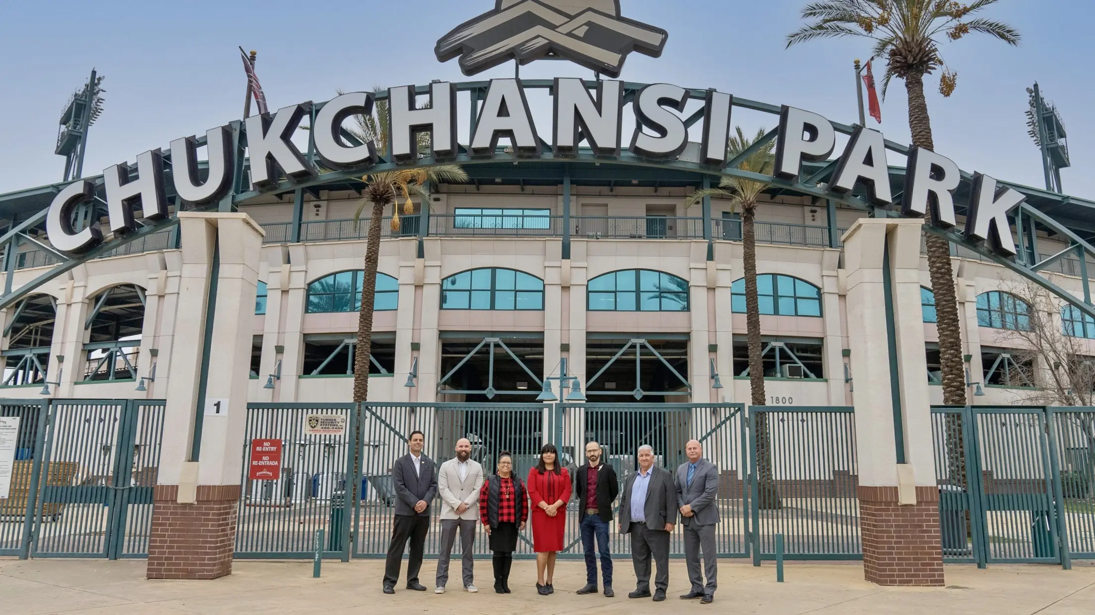 Exterior view of Chukchansi Park with a group of people in front.