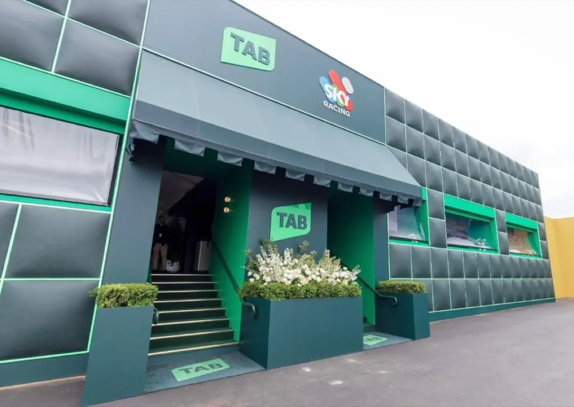 Exterior view of a TAB building with green accents and entrance stairs.