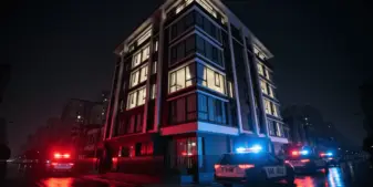 Luxury townhouse with police vehicles outside at night during major illegal betting operation raid in Taiwan