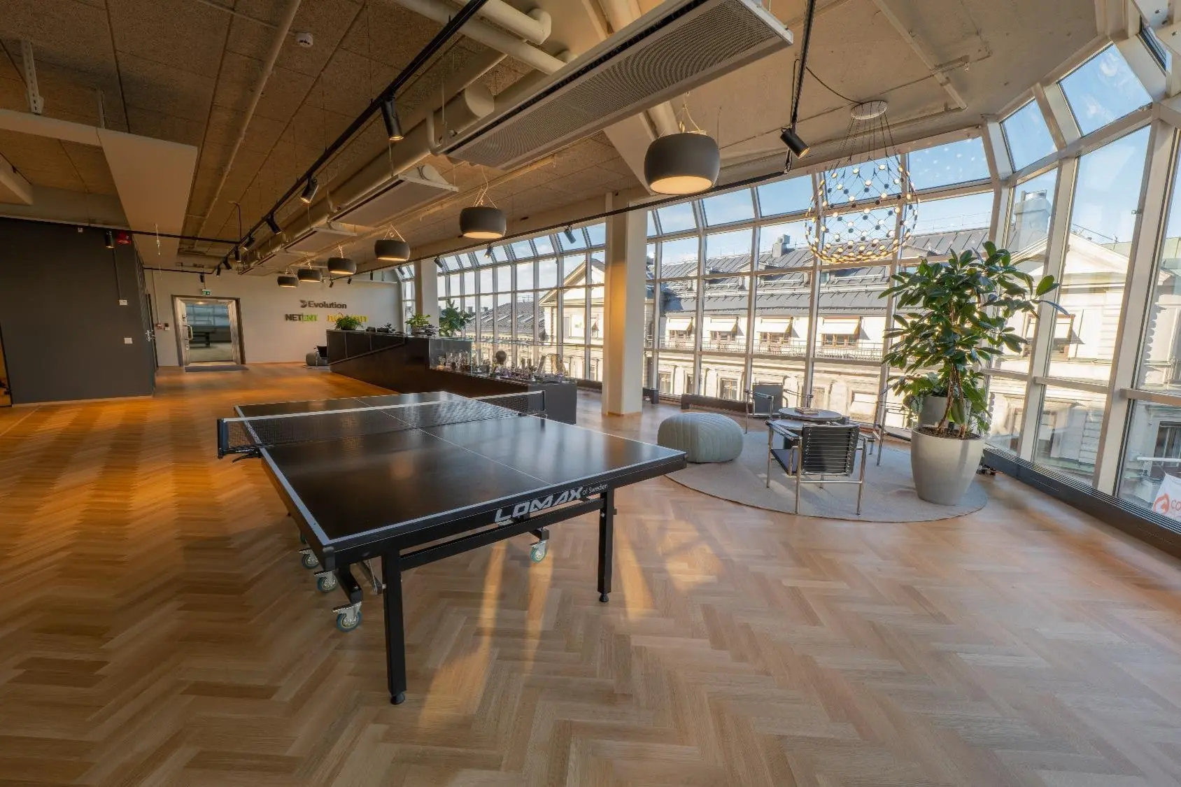 Interior of Evolution AB headquarters in Stockholm featuring a ping pong table and modern office lounge area