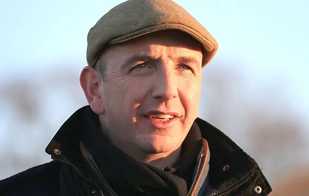 Close-up portrait of horse racing trainer Fergal O'Brien wearing a flat cap and black jacket.