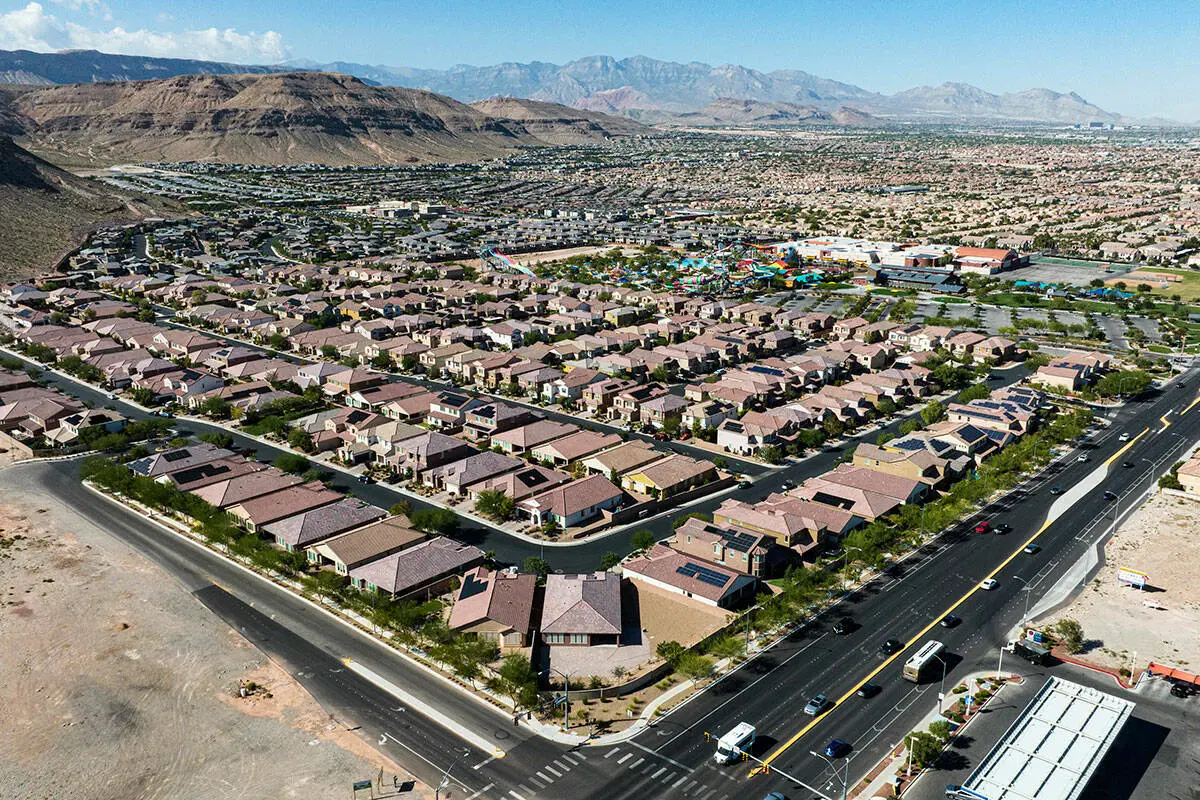 Aerial view of a residential neighborhood with brown roofed houses near a main road in Las Vegas, Nevada