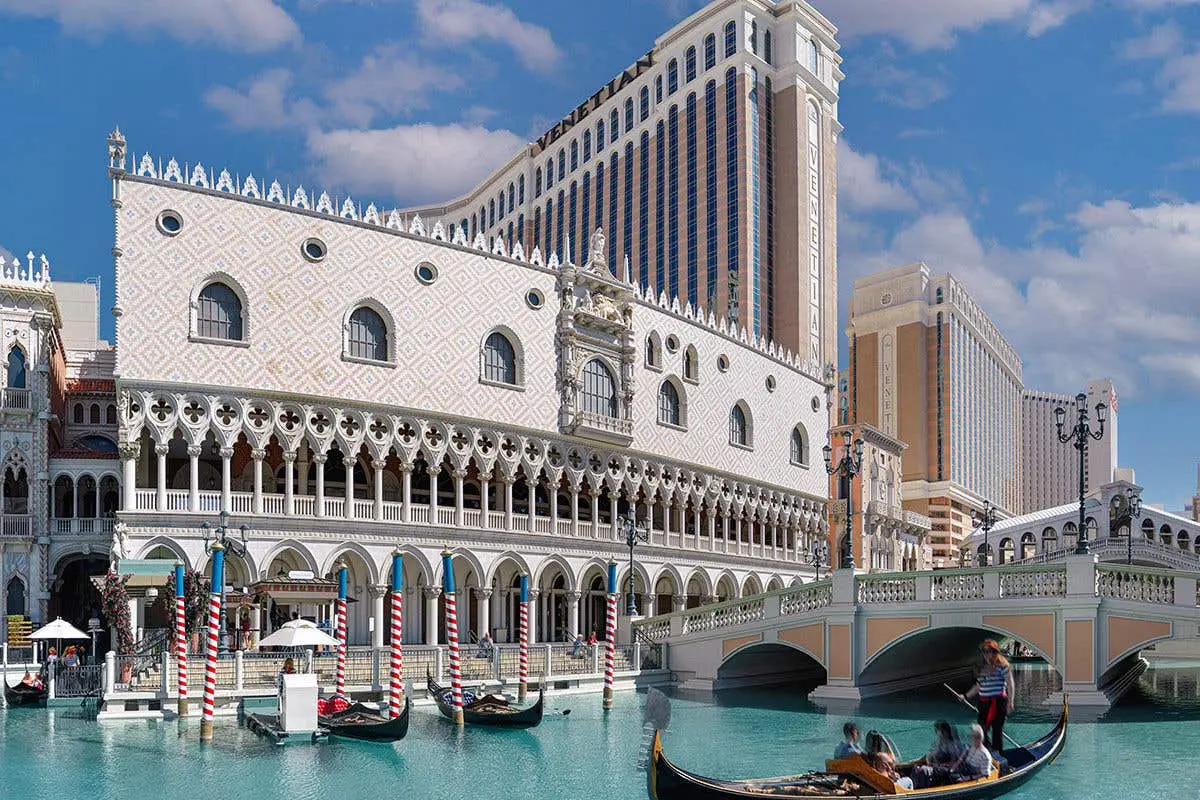 The Venetian Resort Las Vegas exterior featuring the Doge's Palace replica and gondolas on a canal.