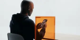 AI-generated gambling advert avatar under regulatory scrutiny on a smartphone