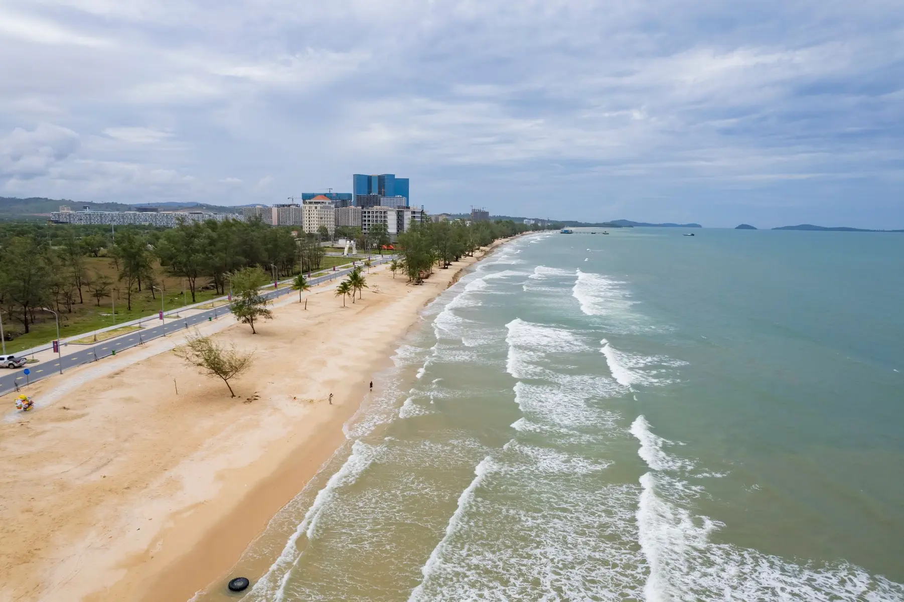 Aerial view of a sandy beach and luxury high-rise hotel buildings in Sihanoukville, Cambodia