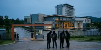 Cambodian casino resort entrance under regulatory scrutiny at dusk